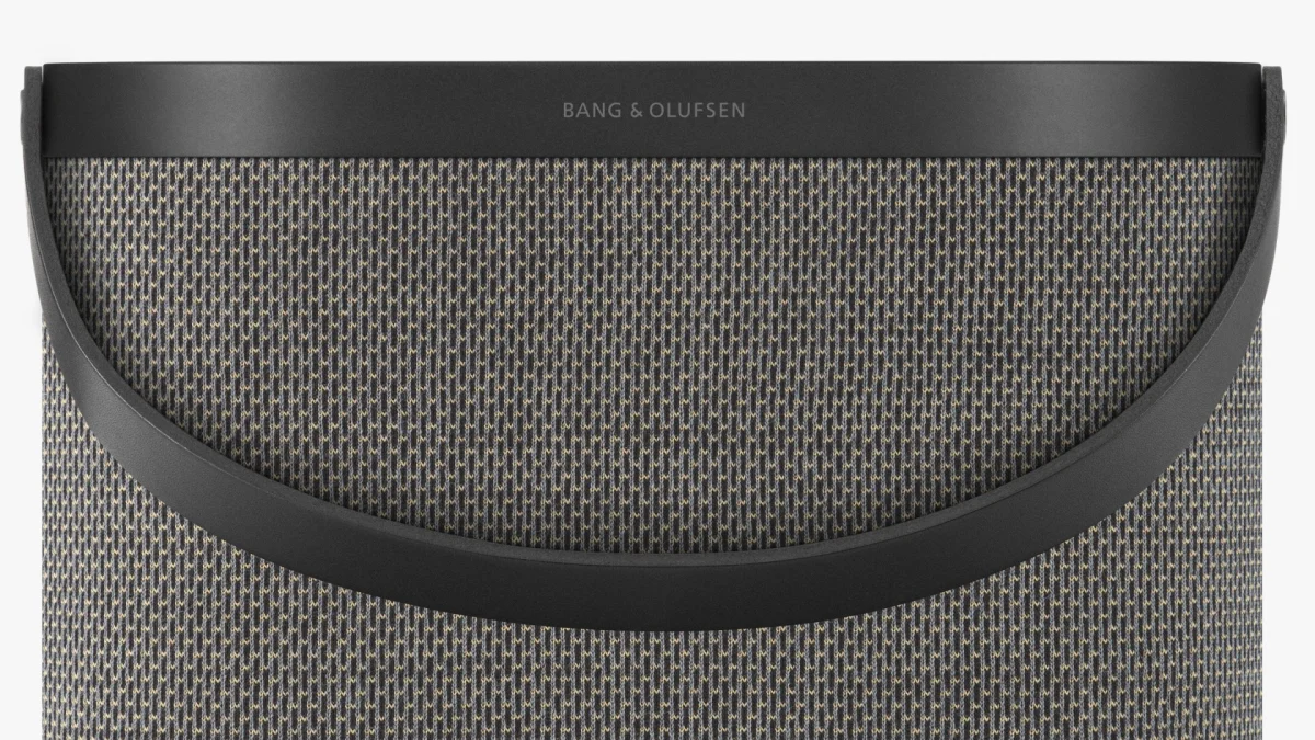 Bang & Olufsen portable speaker featuring a textured fabric body and a black carrying handle.