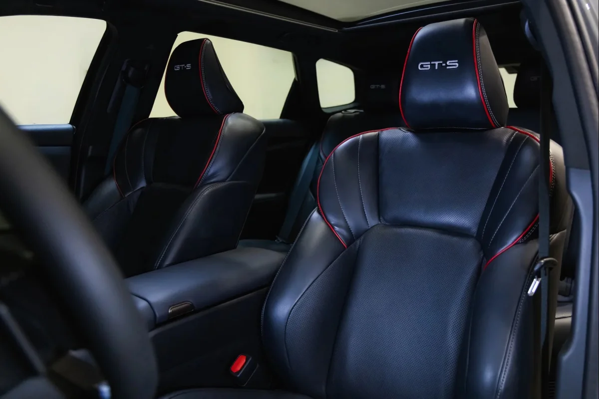 Black leather car seats with red trim and GT-S logos embroidered on the headrests.
