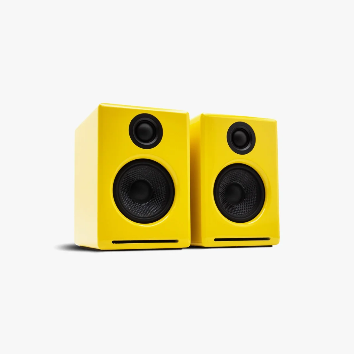 Pair of glossy yellow bookshelf speakers with black drivers and front bass ports on a white background.