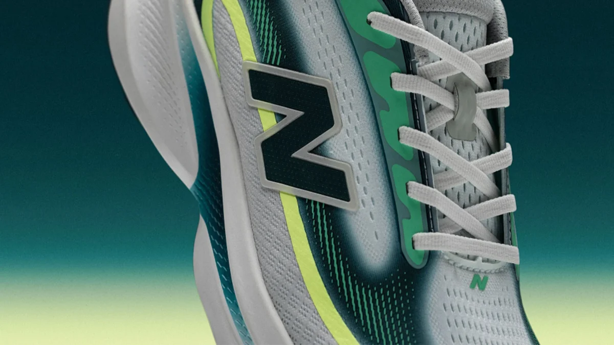 Close-up of a gray and green New Balance running shoe with white laces and a cushioned sole.
