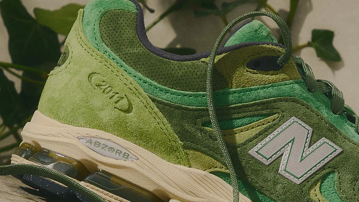 Green suede New Balance sneaker with ABZORB cushioning.