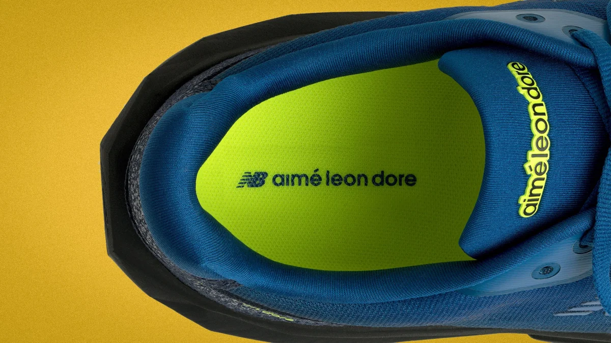 Top view of a blue sneaker with neon green insole.