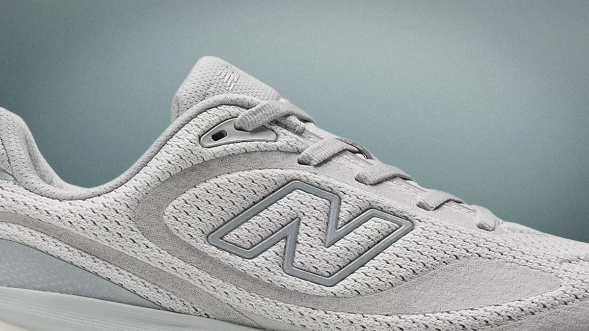 Light gray New Balance sneaker with mesh fabric and suede accents.