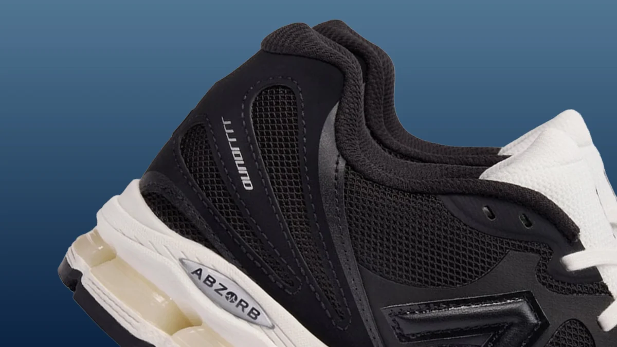 Close-up of black and white New Balance sneaker with ABZORB cushioning and mesh panels.