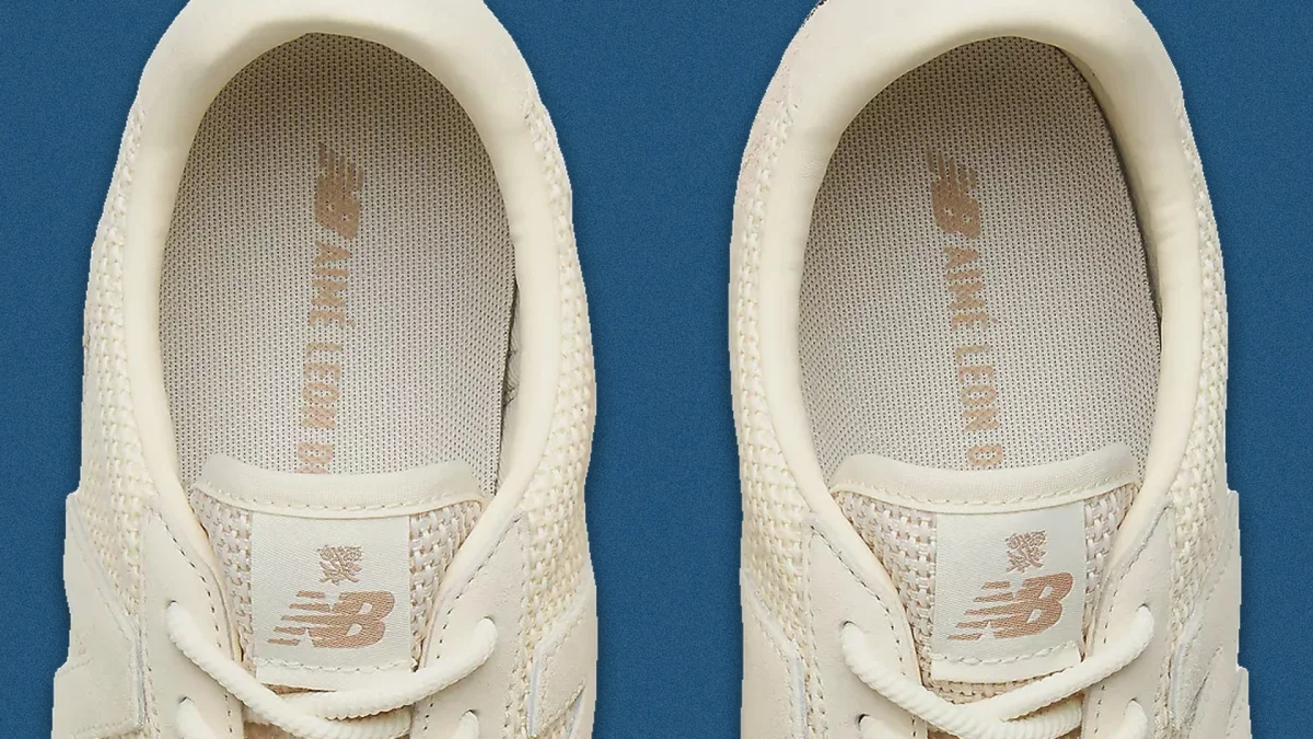 Close-up of cream-colored New Balance sneakers.