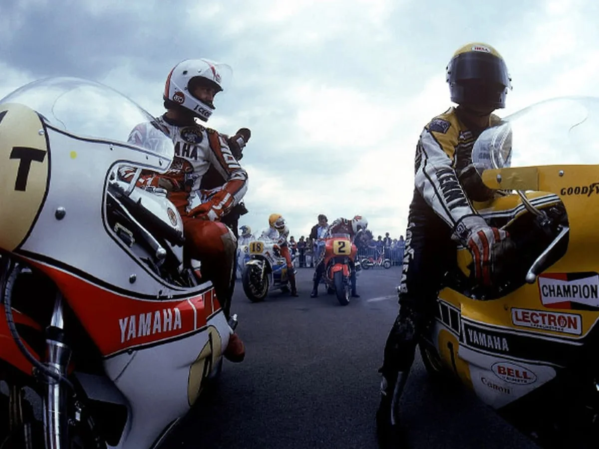 Two Yamaha motorcycles positioned at a starting line.