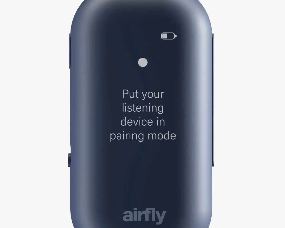 Blue AirFly device with a screen displaying a battery icon and the text Put your listening device in pairing mode.