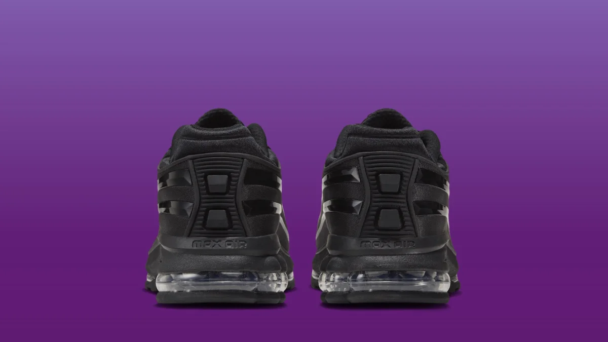 Back view of black Nike Air Max sneakers featuring transparent air cushioning units in the heels.