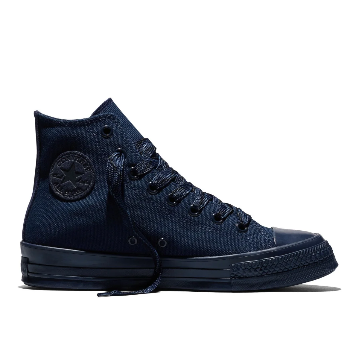 Navy blue high-top Converse sneaker featuring matching laces, eyelets, and a rubber sole.