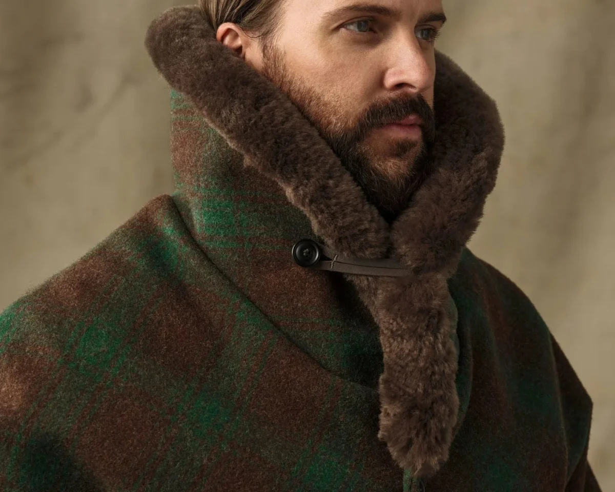 Brown and green plaid wool coat featuring a thick, dark brown shearling collar.