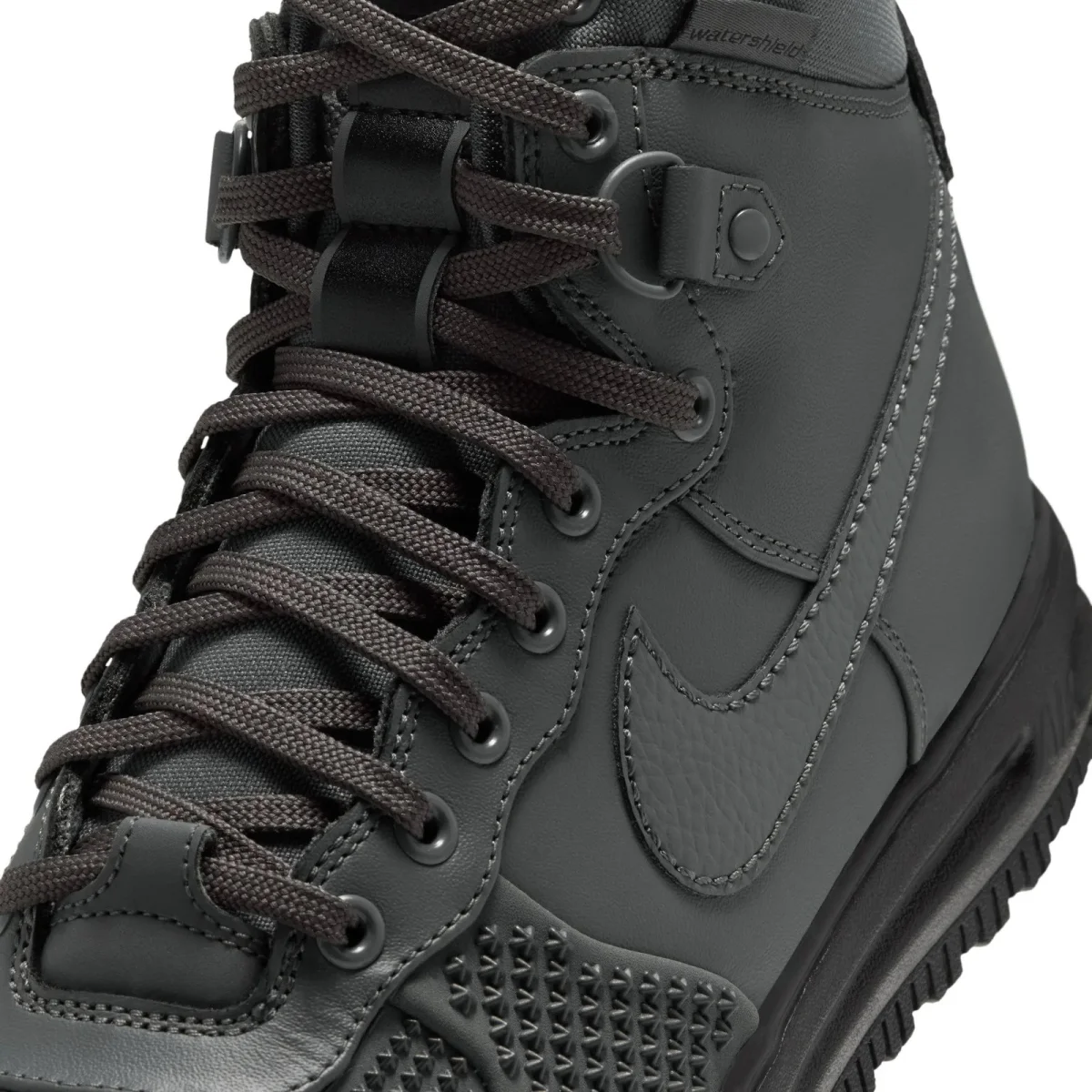 Dark grey high-top sneaker featuring a textured Nike swoosh, round laces, and Watershield branding on the collar.