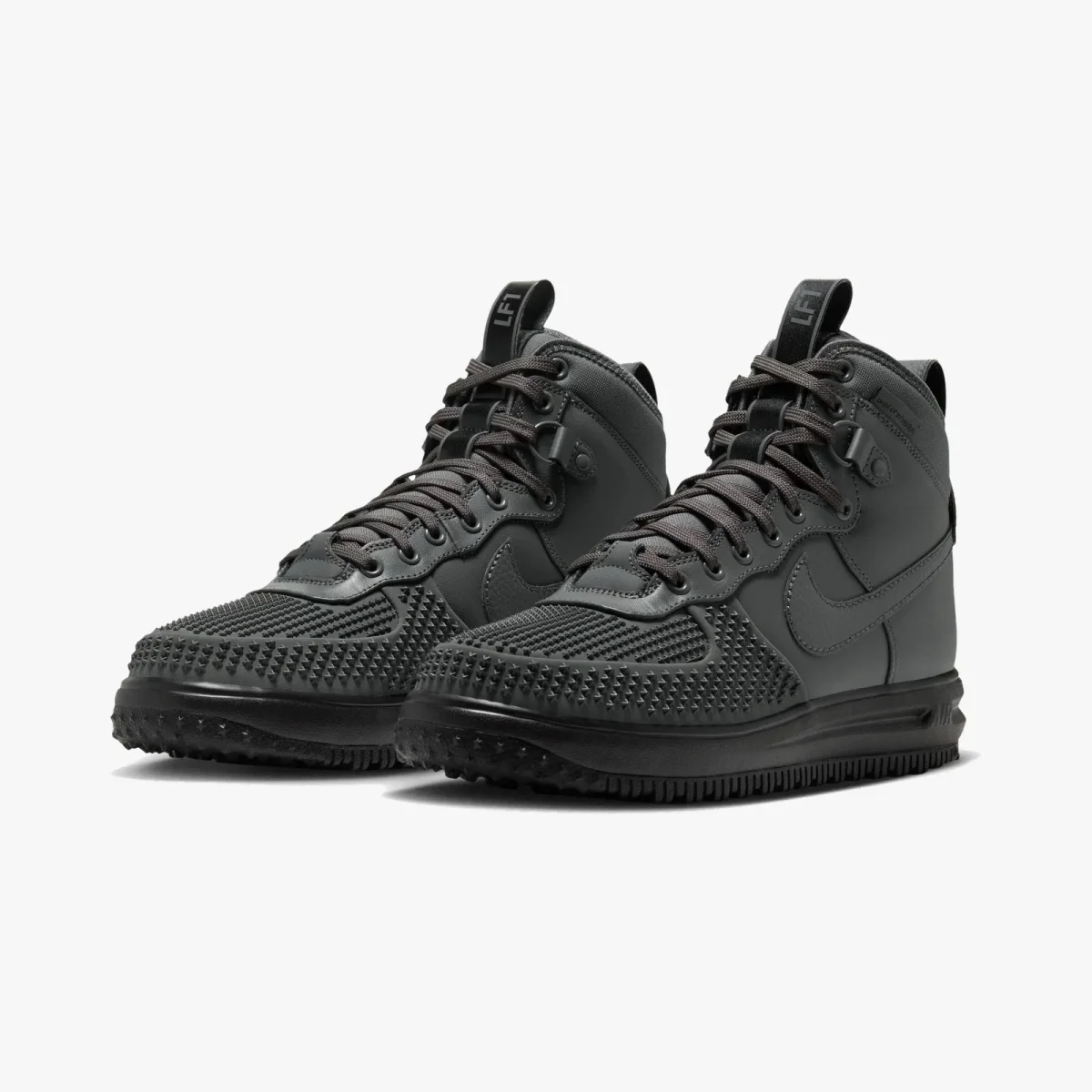 Dark grey high-top sneaker featuring a textured, studded toe cap and a rugged rubber outsole.