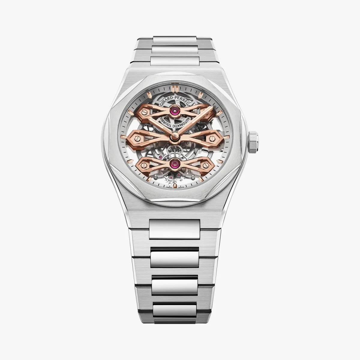 Girard-Perregaux Laureato skeleton watch featuring a silver-tone metal link bracelet, rose gold bridge accents, and a visible tourbillon movement on a white dial.