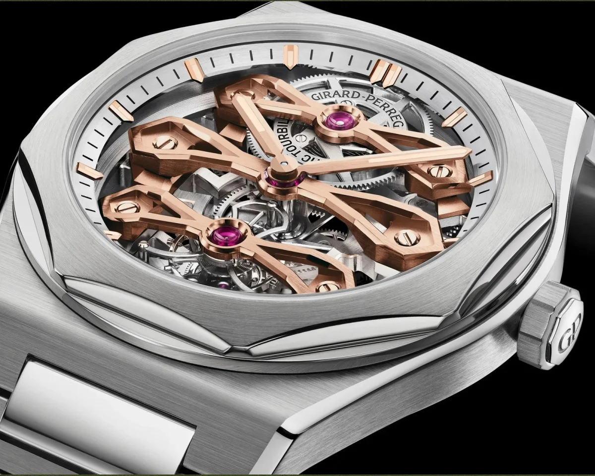 Girard-Perregaux skeleton watch in a close-up view, featuring a brushed stainless steel octagonal bezel and rose gold gear bridges over a visible mechanical movement.