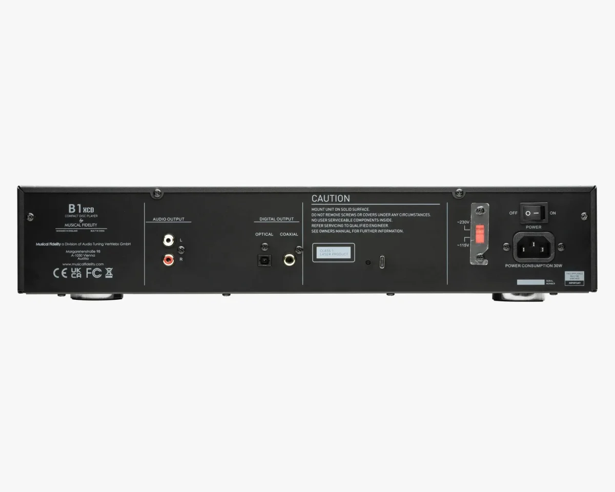 Rear panel of a black Musical Fidelity B1 XCD compact disc player, featuring analog and digital output ports, a voltage selector switch, and a power input.