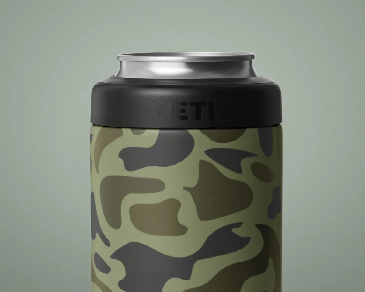 YETI can cooler featuring a green and black camouflage pattern with a black rim.