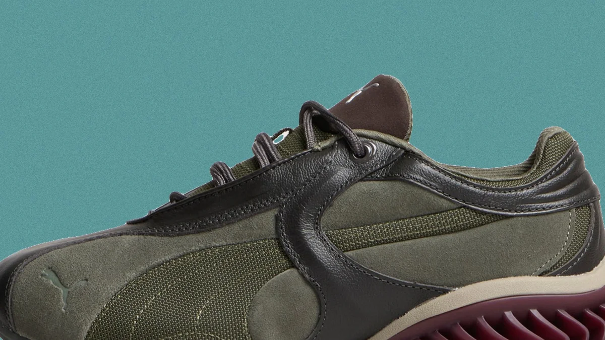Olive green and brown Puma sneaker featuring a textured midsole.