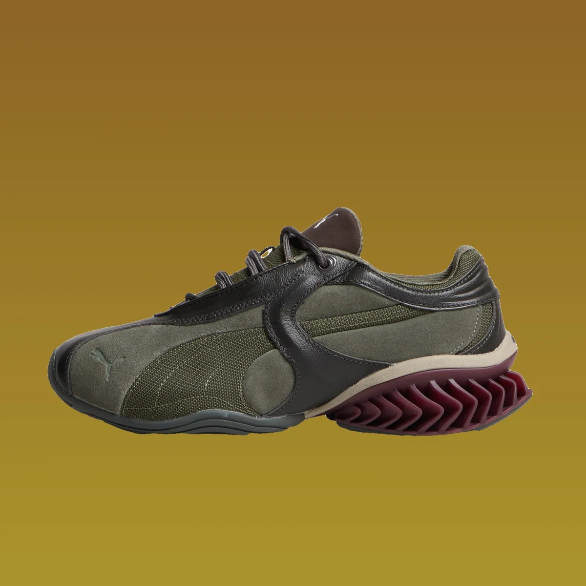 Olive green and dark brown Puma sneaker featuring a jagged maroon heel.