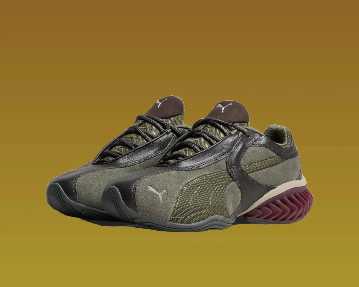 Olive green and dark brown Puma sneaker featuring a ridged burgundy heel.