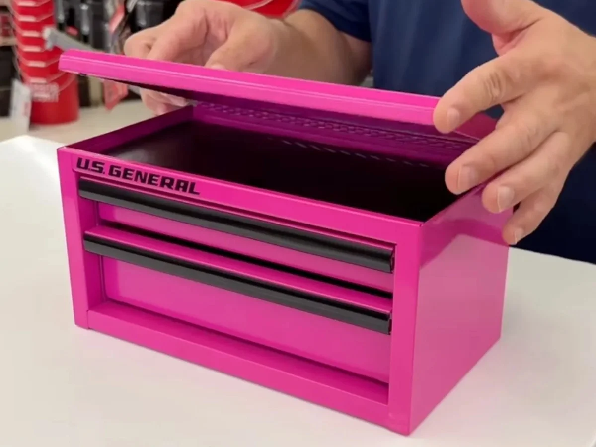 Pink U.S. General portable toolbox with two drawers and a hinged lid being opened in hands.