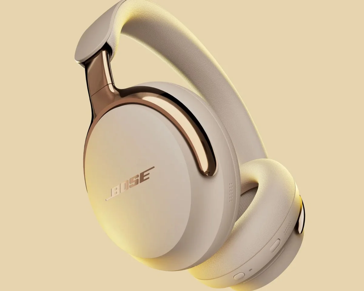 Bose over-ear headphones in beige with metallic copper accents.