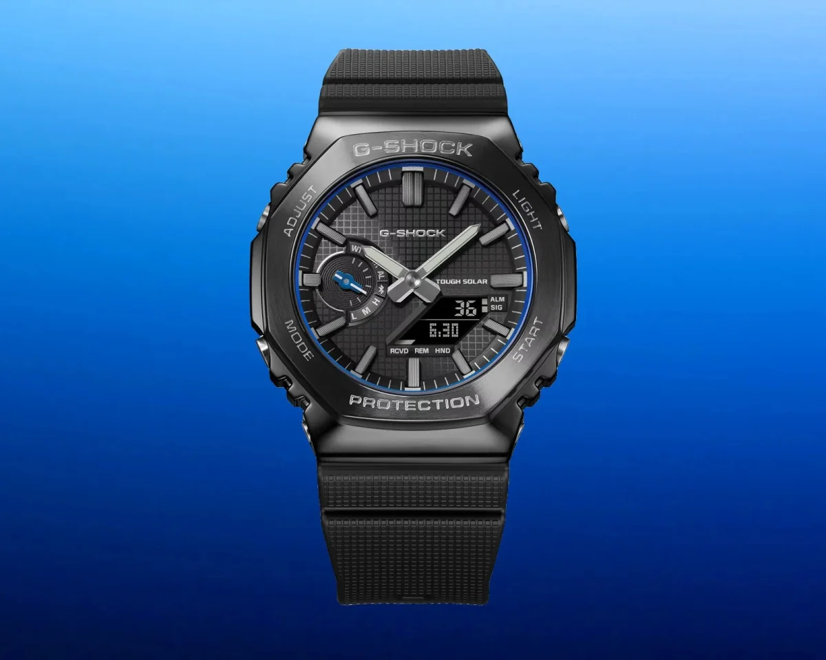 Black G-Shock ana-digi watch with a textured resin strap, metallic bezel, and a black dial featuring luminescent hands, an inset sub-dial, and a digital display showing 6:30.