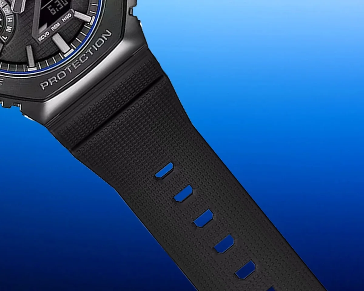 Black resin digital-analog watch with a textured strap, buckle holes, and the word PROTECTION engraved on the bezel.