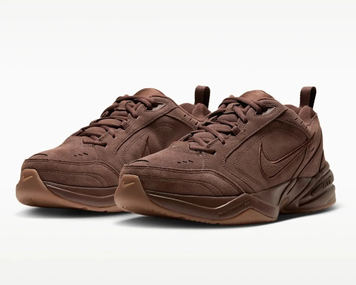 Brown Nike Air Monarch sneakers featuring a suede upper and a gum rubber outsole.