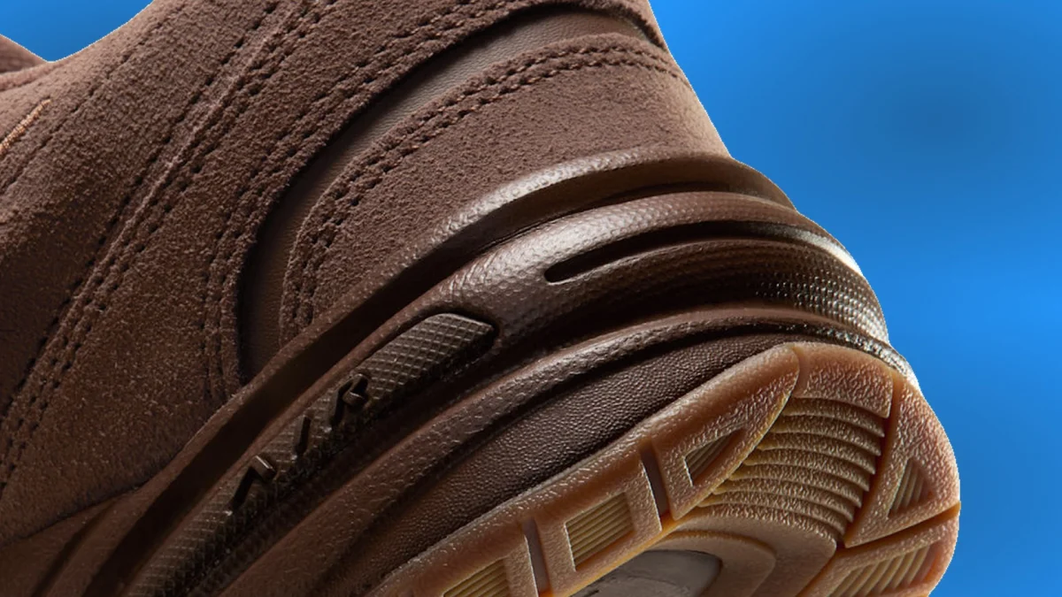 Close-up of the heel of a brown suede sneaker, featuring a molded midsole and a textured gum rubber outsole.