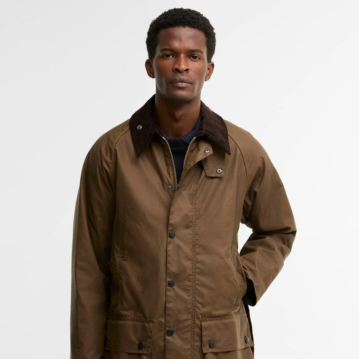 Brown Barbour wax jacket featuring a dark brown corduroy collar and a snap-button closure.