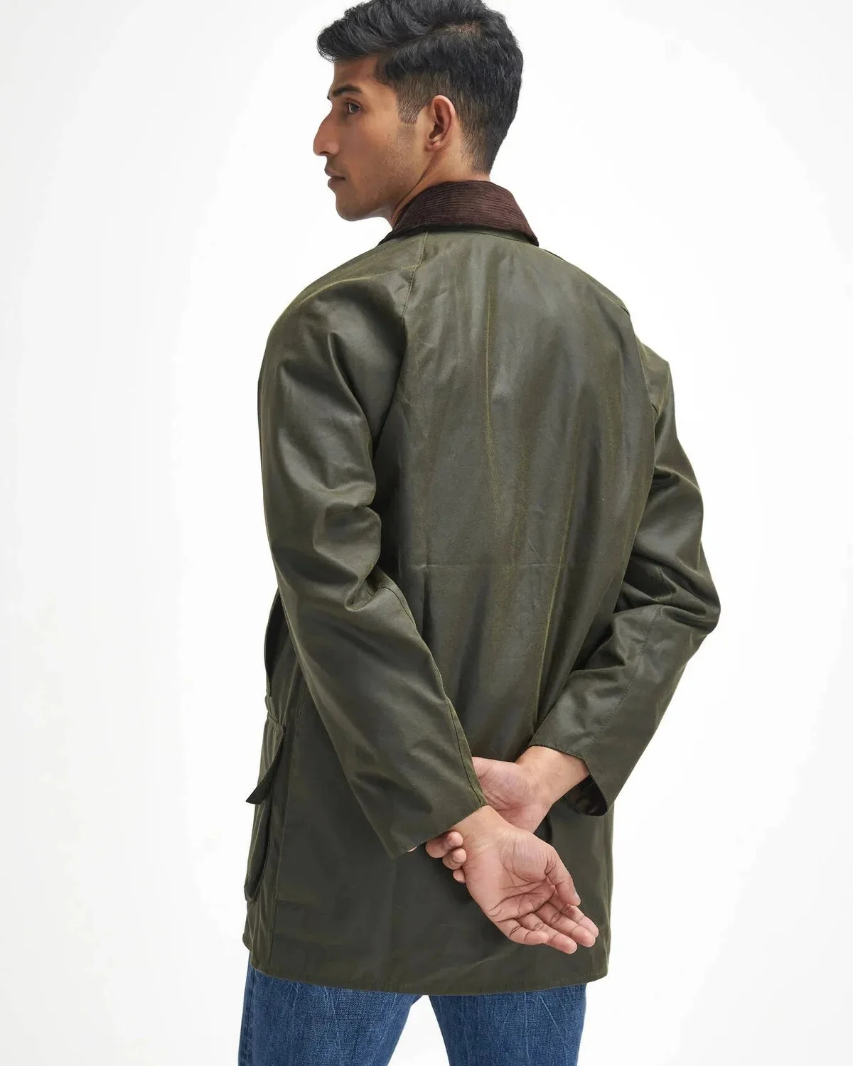 Olive green waxed jacket with a brown corduroy collar.