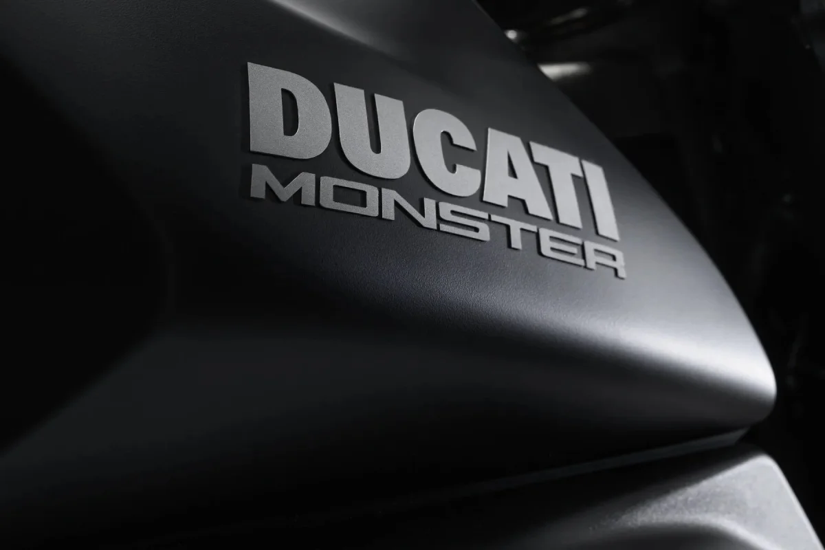 Ducati Monster logo embossed on a matte black motorcycle fuel tank.