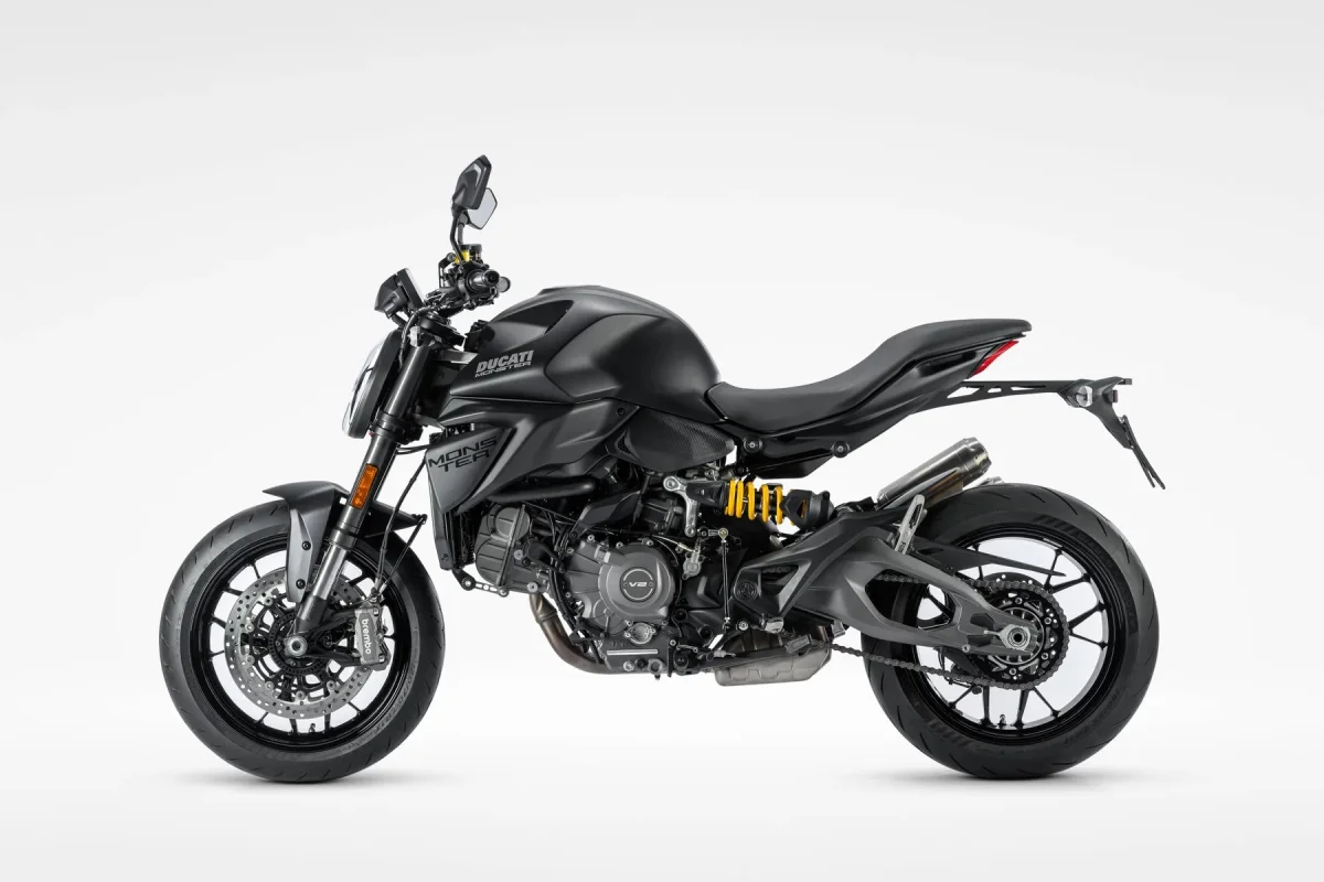 Matte black Ducati Monster motorcycle, viewed from the side.