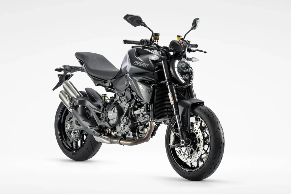 Black Ducati Monster motorcycle parked at an angle against a white background.