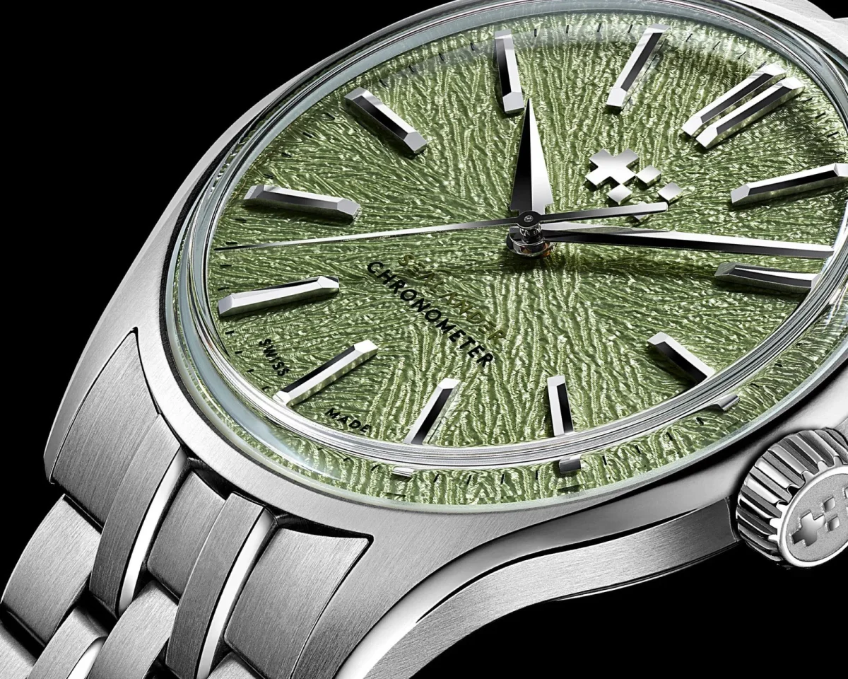 Christopher Ward wristwatch featuring a textured pale green dial with silver indices and a stainless steel link bracelet.