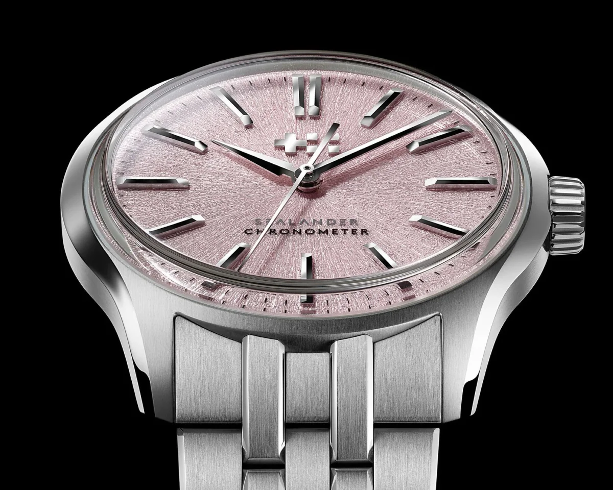 Christopher Ward Sealander chronometer watch with a textured pink dial and silver-tone metal link bracelet.
