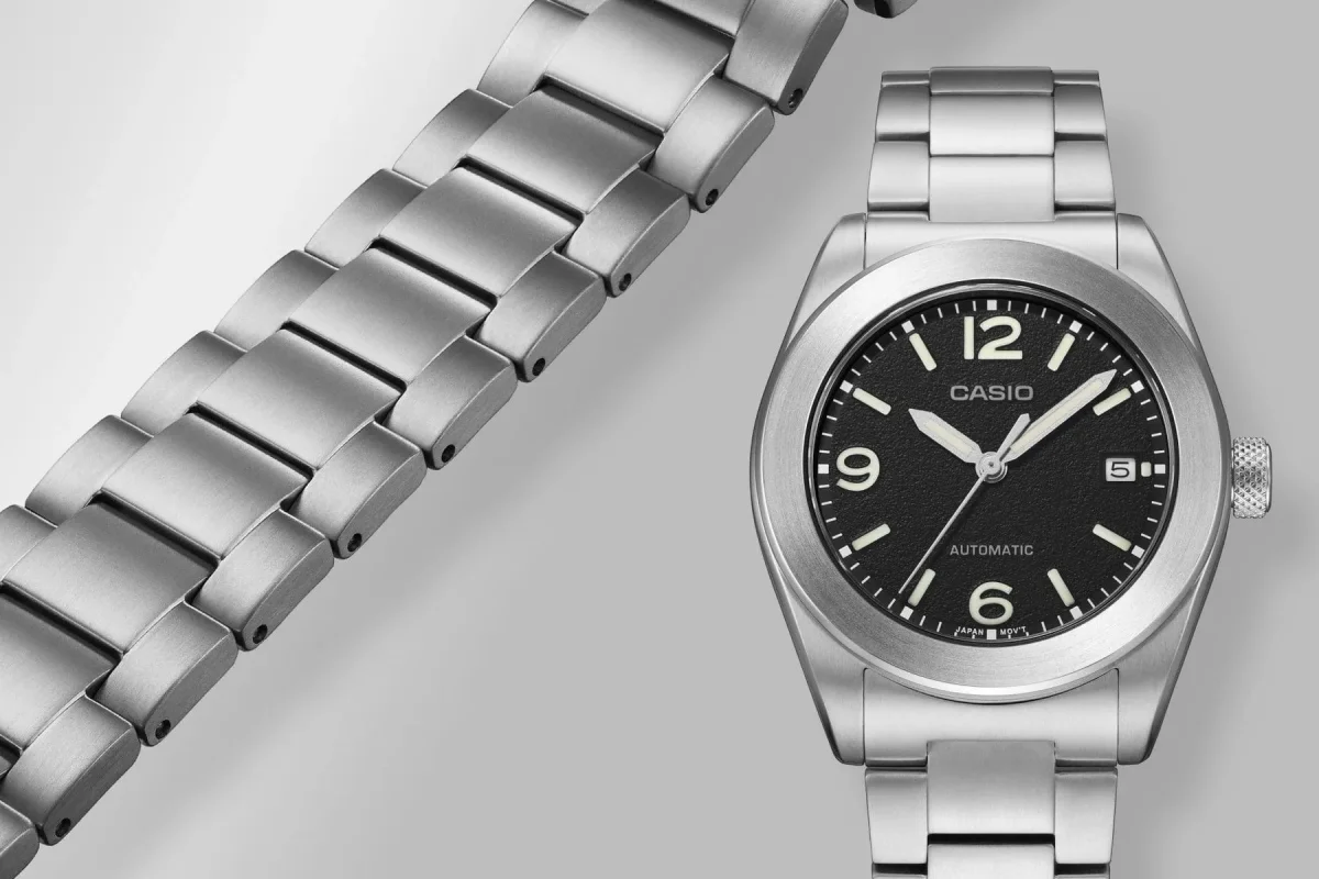 Casio automatic watch featuring a black dial, white numerals, and a stainless steel link bracelet.