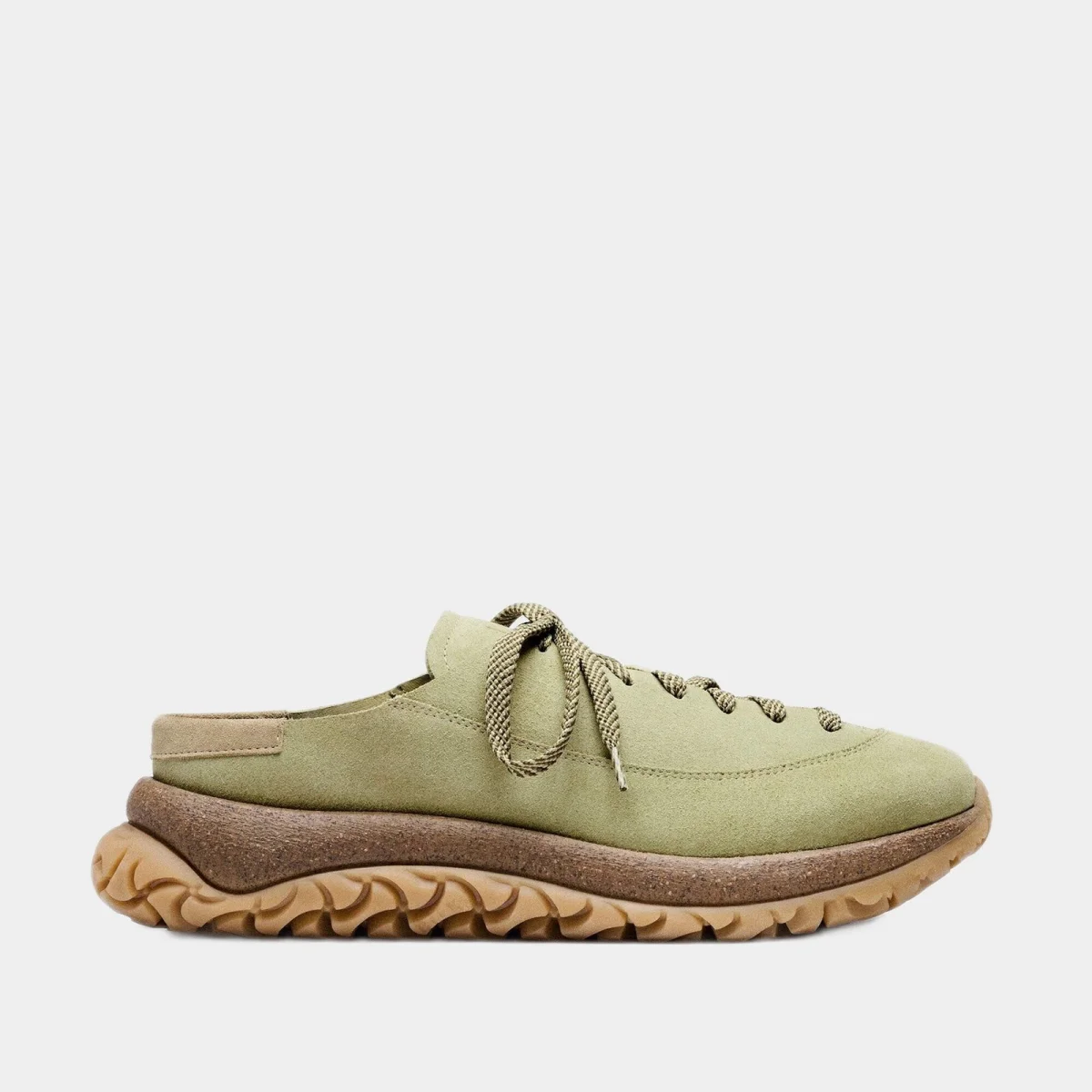 Olive green suede mule shoe featuring patterned laces and a thick, textured brown rubber sole.