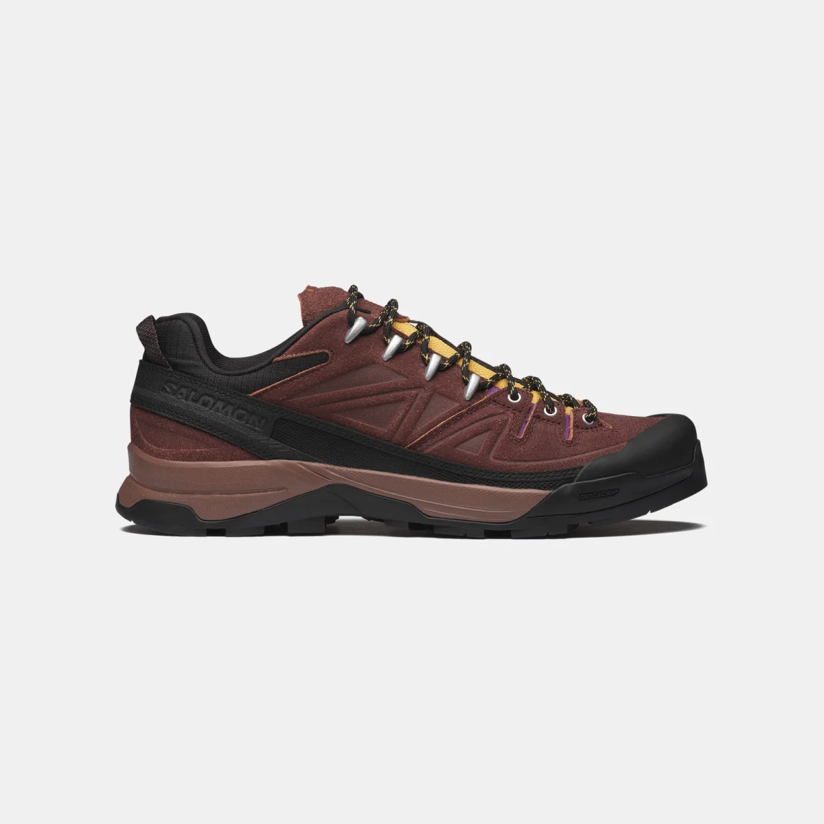 Brown and black Salomon hiking shoe featuring a rugged sole, mesh and leather upper, metal eyelets, low-cut design, shown on a white background.