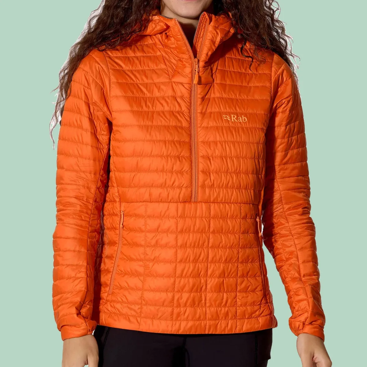 Bright orange hooded pullover jacket with a half-zip and the Rab logo on the chest.