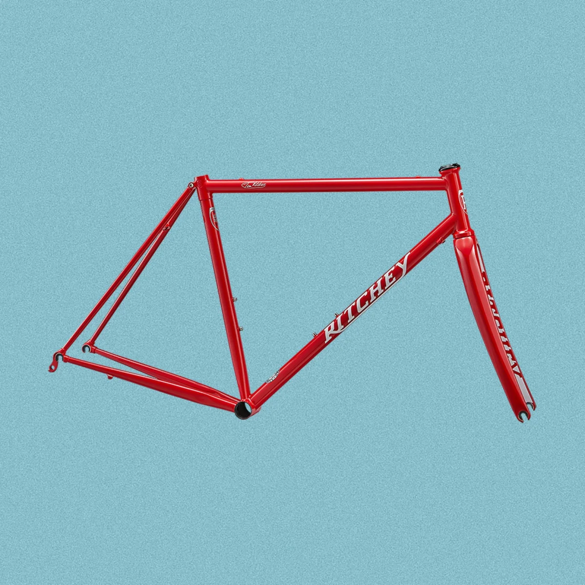 Red Ritchey bicycle frame with logo on downtube, displayed against a plain blue background.