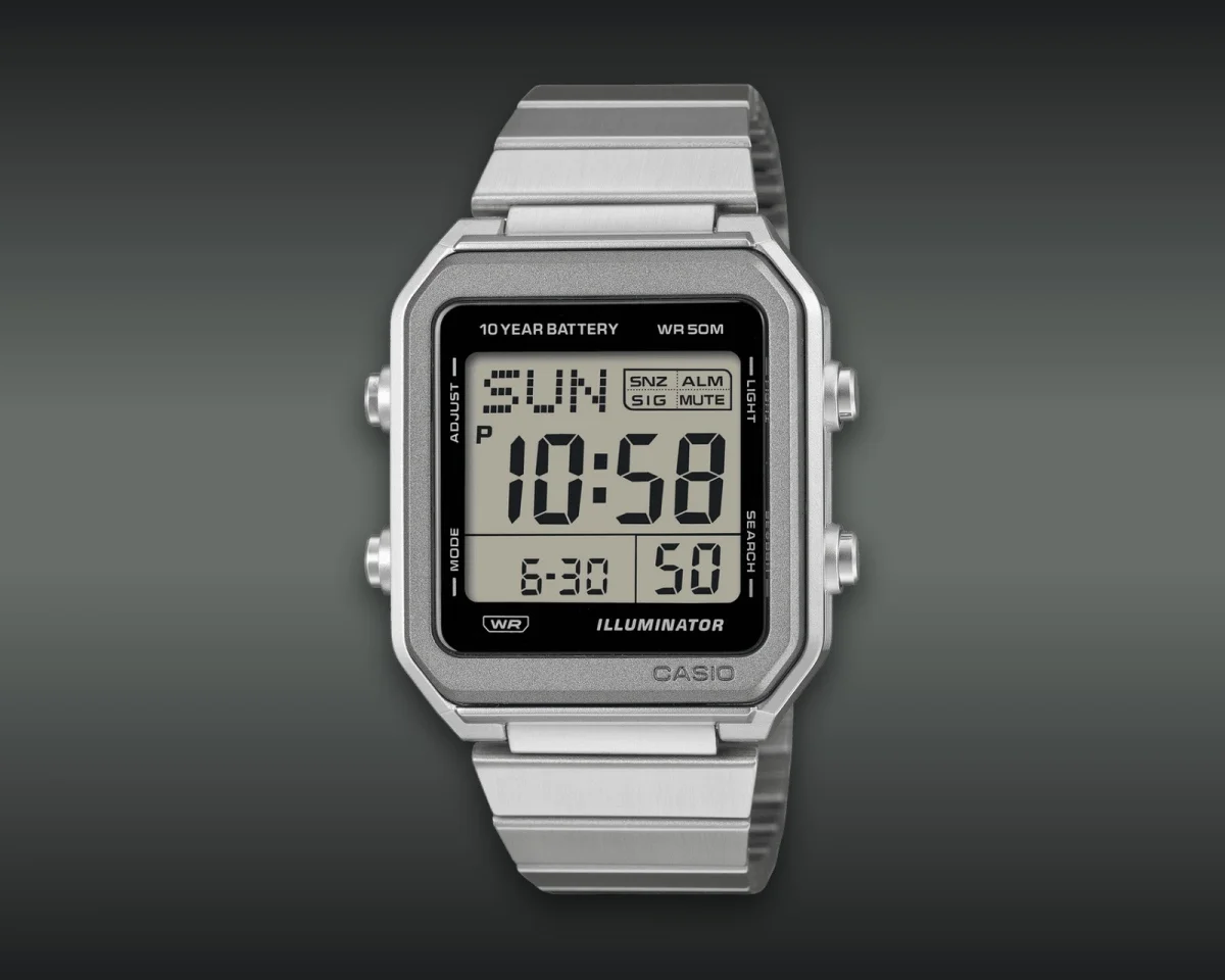 Casio digital watch featuring a silver-tone metal case and band with a black rectangular dial displaying the time, day, and date.