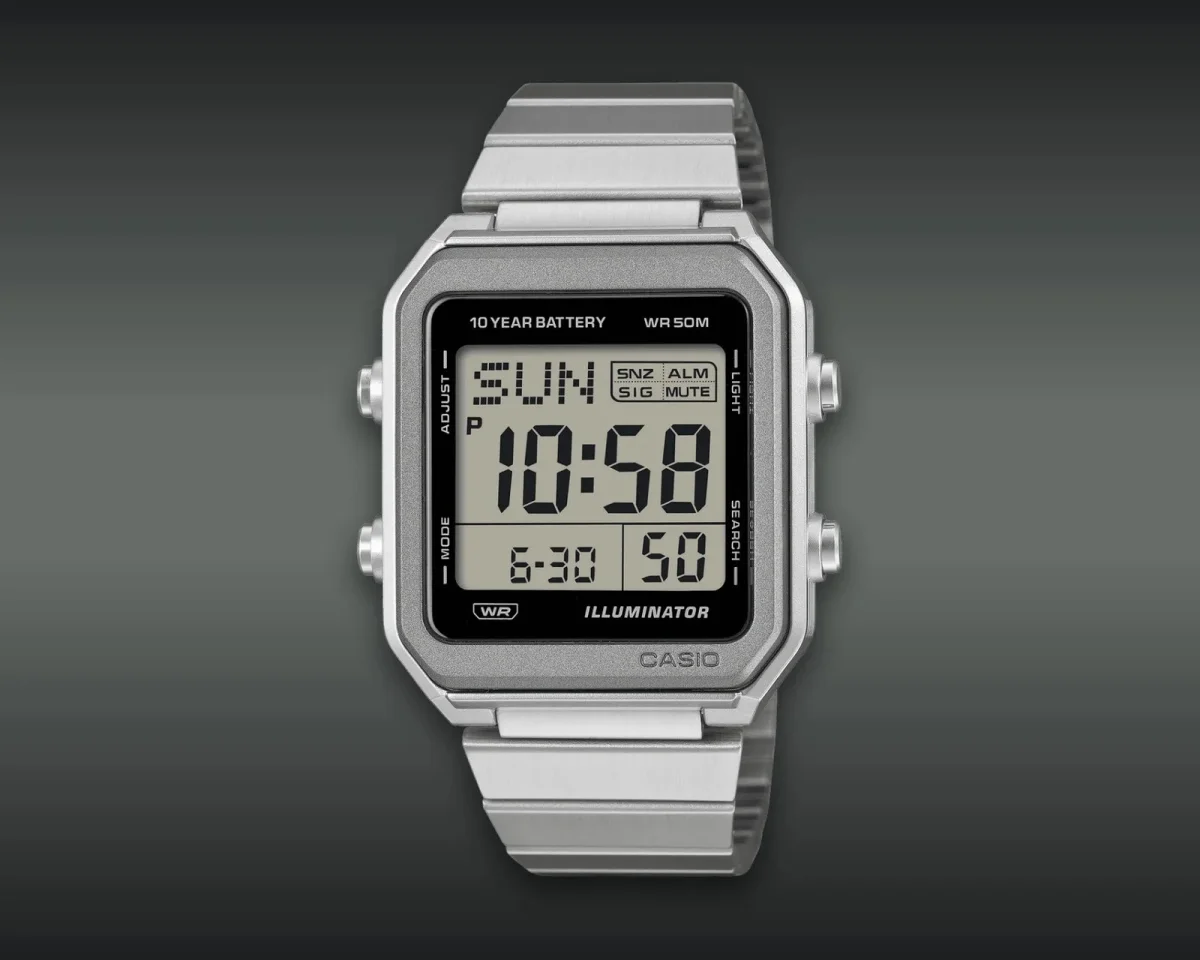 Casio digital watch featuring a silver-tone metal case and band with a black rectangular dial displaying the time, day, and date.