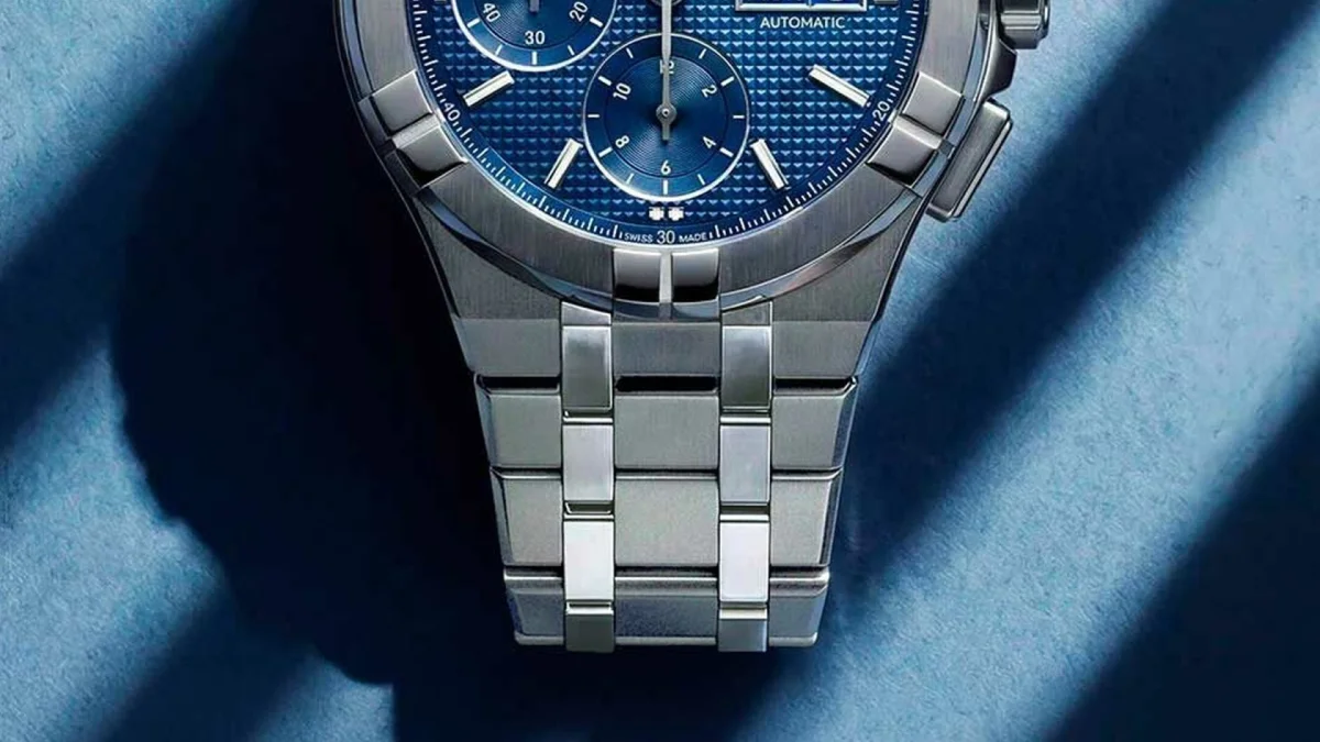 Stainless steel chronograph watch featuring a blue patterned dial and a link bracelet.