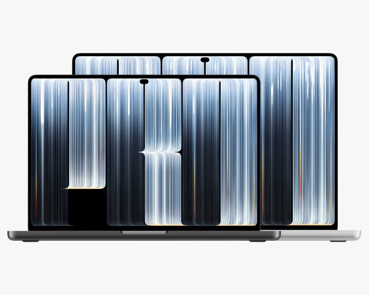 Space black and silver laptops shown side by side, displaying a screen graphic of the word PRO composed of abstract white vertical lines.