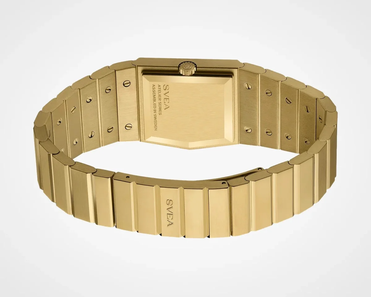 Back view of a gold-tone rectangular wristwatch with a metal link bracelet, featuring the SVEA logo engraved on the clasp and the case back.
