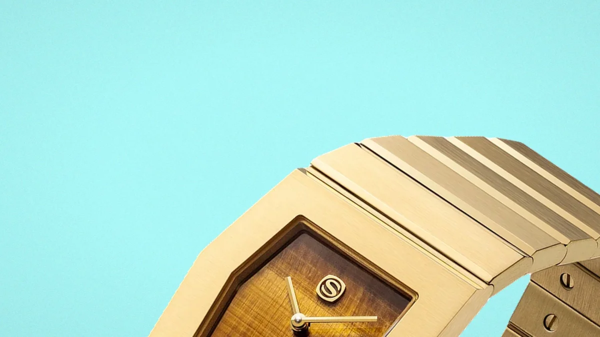 Gold-toned metal watch with an integrated link bracelet and a rectangular wood grain dial featuring a central logo and slender hands.