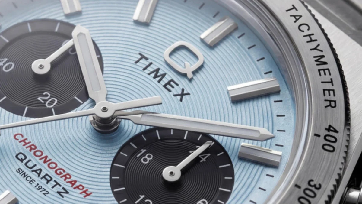 Close-up of a Timex chronograph quartz watch with a light blue dial and black subdials.