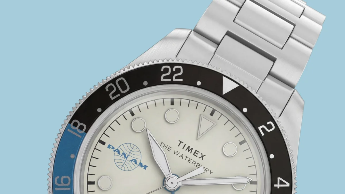 Timex Waterbury Pan Am watch featuring a cream dial, a blue and black 24-hour bezel, and a silver-tone metal bracelet.