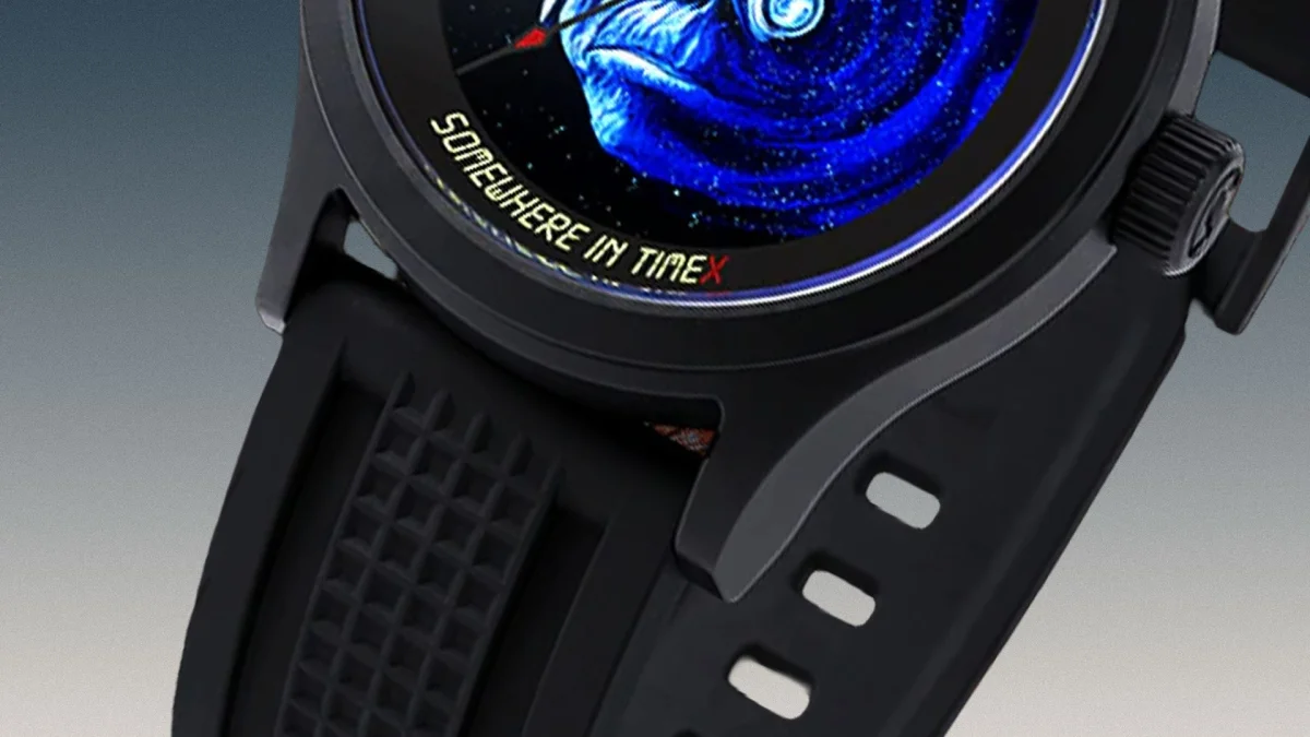 Black watch with textured rubber strap and a blue fish design on the dial with